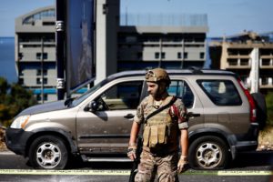 A military police looks on at the site following, what the Health Ministry says was an Israeli strike on a car, near the C...