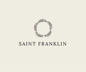 SAINT FRANKLIN in a stylized classical font with a simple wreath above | Logo Design by Andrew