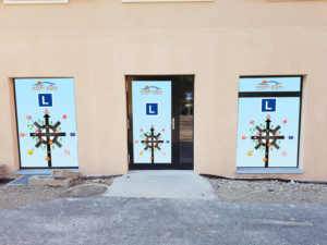 Posters for showcases and a door for a driving school In front of a university | Newspaper Ad Design by ecorokerz