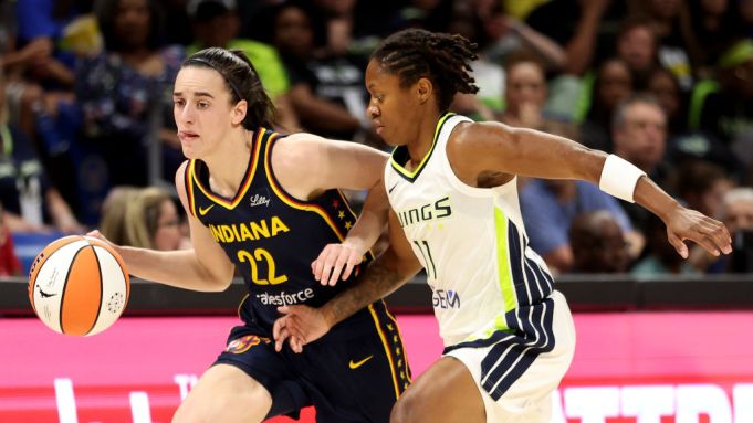 Caitlin Clark #22 of the Indiana Fever dribbles against Crystal Dangerfield #11 of the Dallas Wings