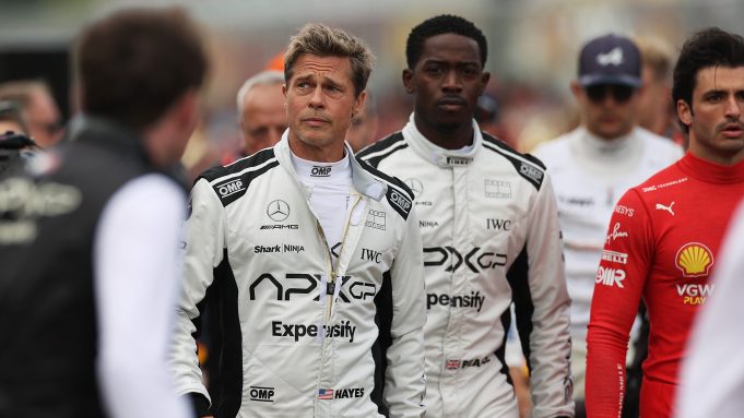 Brad Pitt, and Damson Idris, co-star, walk on the grid during the F1 Grand Prix of Great Britain at Silverstone Circuit on July 9, 2023 in Northampton, England.