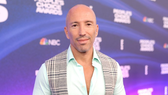 Jason Oppenheim poses on a red carpet.