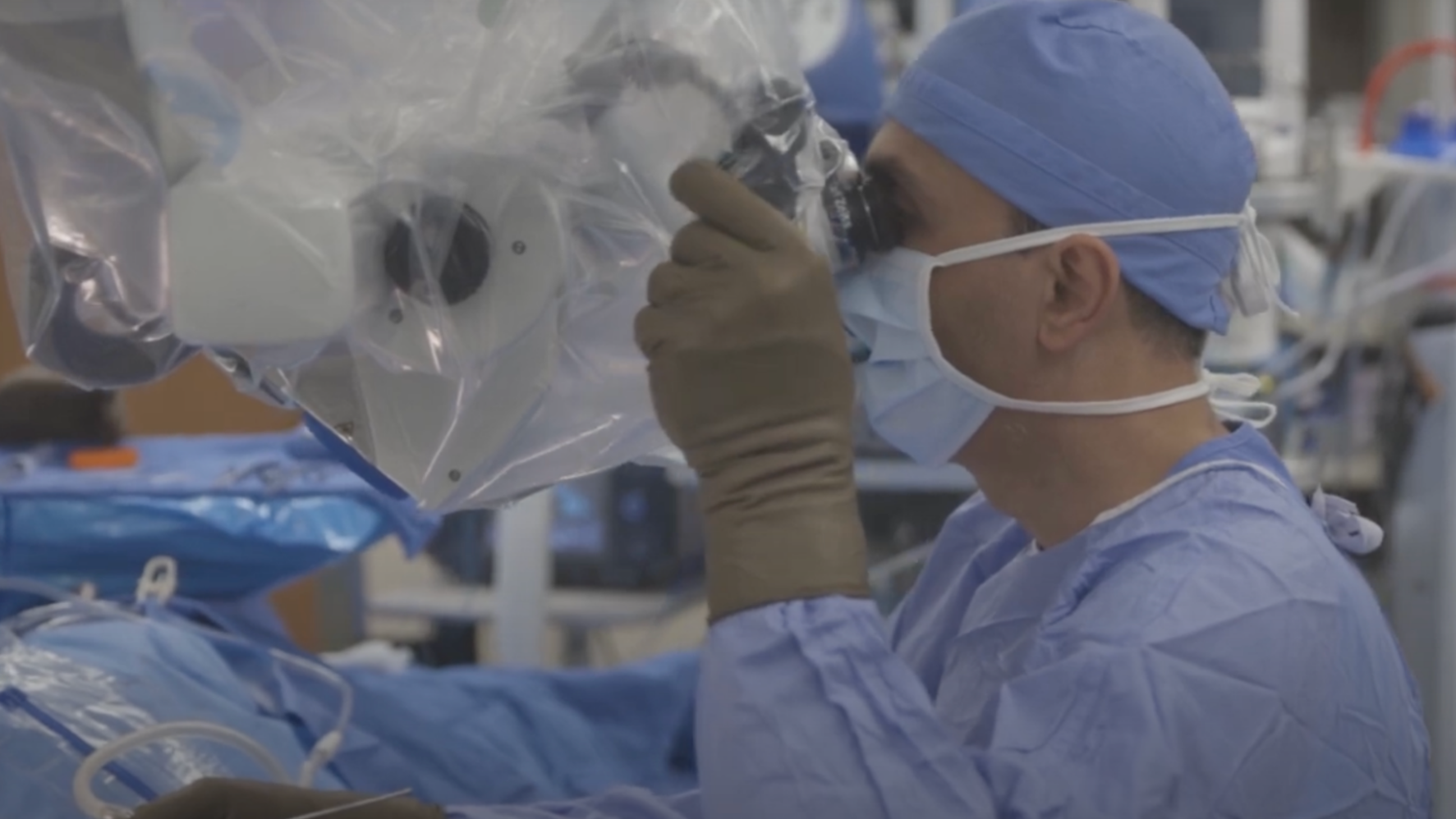 A surgeon using a medical device in an operating room.