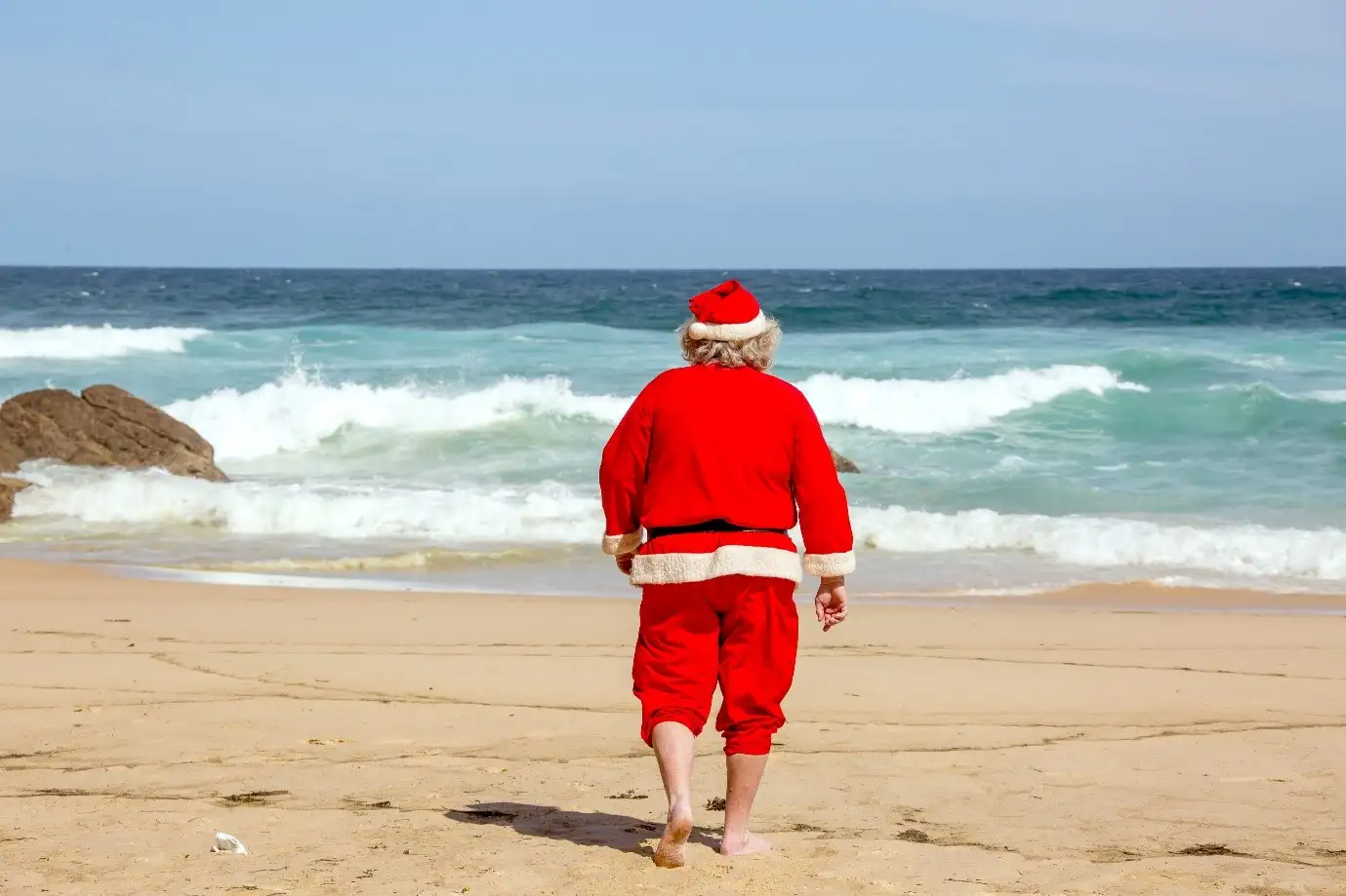 Man dressed in Santa Claus in beach