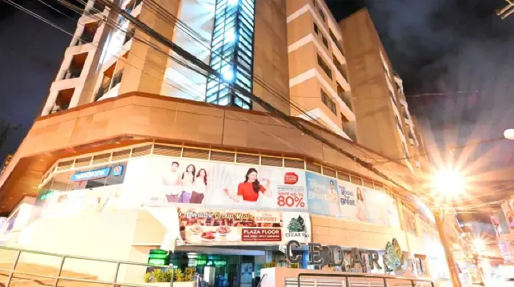 Exterior of hotel building illuminated at night at Cedar Peak Condominium by Tripsters Hub