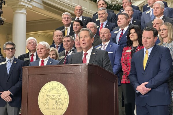 FILE - Georgia Gov. Brian Kemp announces a plan for a further cut to Georgia's state income tax rate, Dec. 4, 2023, at the Georgia Capitol in Atlanta. That plan, which is retroactive to Jan. 1, 2024, will take effect on Monday, July 1. (AP Photo/Jeff Amy, File)