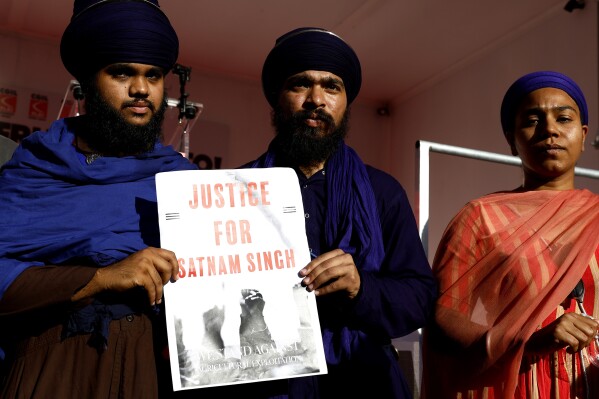 Members of the Indian community in Italy protest in Latina, some 60 kilometers south of Rome, Saturday, June 22, 2024, asking justice for Satnam Singh, an Indian laborer, bled to death after his arm got stuck in a nylon-wrapping machine and was wrenched off. Police on Tuesday arrested Antonello Lovato, a farm owner on suspicion of homicide after he allegedly refused entreaties by Singh's wife, who also worked at the farm, to call an ambulance, claiming he was already dead. (Cecilia Fabiano/LaPresse via AP)