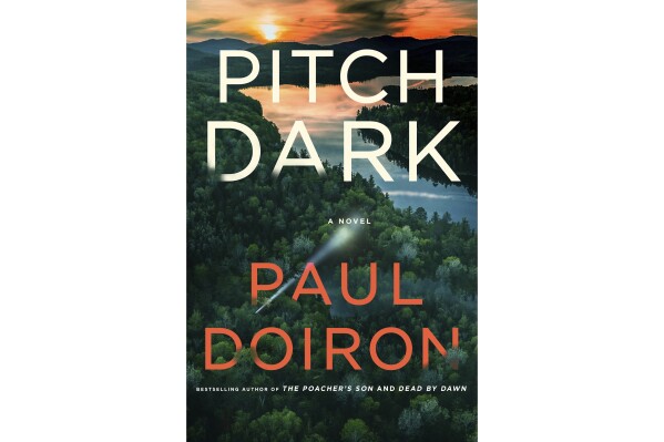 This cover image released by Minotaur shows "Pitch Dark" by Paul Doiron. (Minotaur via AP)