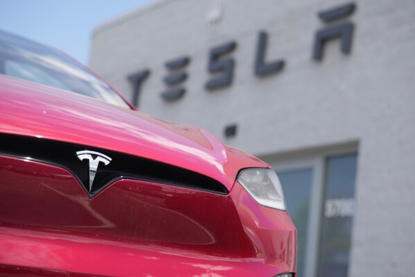FILE - A Model X sports-utility vehicle sits outside a Tesla store in Littleton, Colo., June 18, 2023. An air quality board has ordered electric car manufacturer Tesla to stop illegally polluting the air in the San Francisco Bay Area. (AP Photo/David Zalubowski, File)
