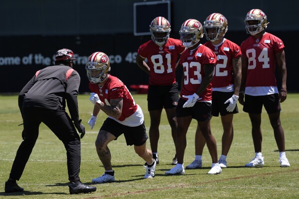 FILE - San Francisco 49ers wide receiver Ricky Pearsall, second from left, takes part in drills with Timothy Patrick (81), Jacob Cowing (83), Monroe Young, second from left, and Terique Owens (84) during the NFL football team's rookie minicamp in Santa Clara, Calif., Friday, May 10, 2024. Across the NFL, teams wrapped up their mandatory minicamps this week leading into about a month-long break before the start of a grueling NFL season that could approach seven months for the teams that make the Super Bowl. (AP Photo/Jeff Chiu)