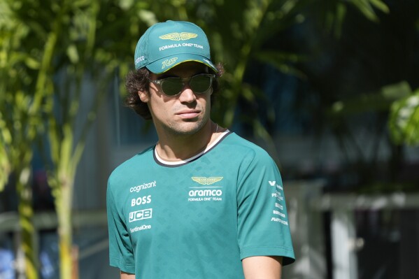FILE - Aston Martin driver Lance Stroll of Canada arrives before the start of the Sprint race at the Formula One Miami Grand Prix auto race at the Miami International Autodrome, Saturday, May 4, 2024, in Miami Gardens, Fla. Canadian driver Lance Stroll will continue racing for Aston Martin into the 2026 season, the Formula 1 team said Thursday, June 27, 2024. (AP Photo/Wilfredo Lee, File)