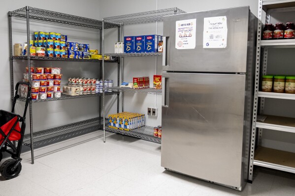 Georgetown University's Hoya Hub on-campus food pantry offers an assortment of food and household supplies for students in need, Friday, June 9, 2023 in Washington. At Georgetown University, the donor-funded pantry is a locked room with shelves of food and toiletries and a refrigerator for perishables. Any students who request help are given the code to unlock the door and can essentially come and go as they need. (AP Photo/Andrew Harnik)