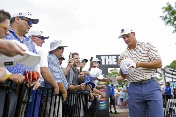 Captain Bryson DeChambeau of Crushers GC signs autographs for fans before the second round of LIV Golf Nashville at The Grove on Saturday, June 22, 2024 in College Grove, Tenn. (Photo by Chris Trotman/LIV Golf via AP)