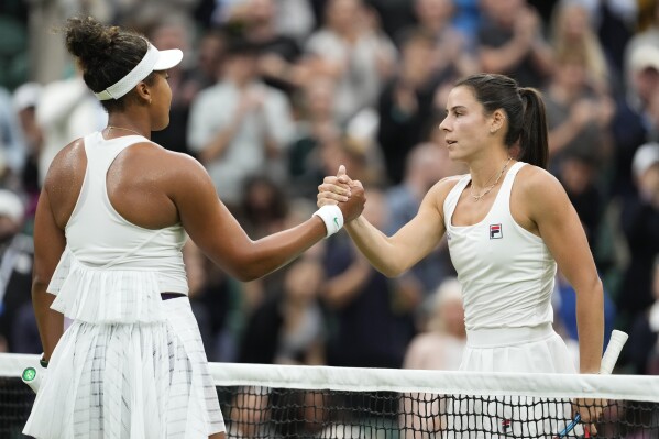 Emma Navarro, right, of the United States is congratulated by Naomi Osaka of Japan following their match on day three at the Wimbledon tennis championships in London, Wednesday, July 3, 2024. (AP Photo/Alberto Pezzali)