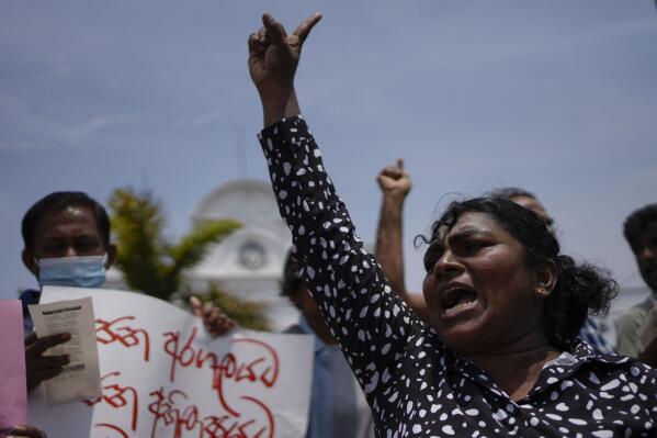 An anti government protester shouts slogans against the recent military eviction of their protest camp outside president's office in Colombo, Sri Lanka, Wednesday, July 27, 2022. Sri Lanka's economic crisis has left the nation’s 22 million people struggling with shortages of essentials, including medicine, fuel and food. (AP Photo/Eranga Jayawardena)