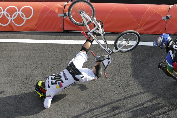 FILE - Colombia's Carlos Mario Oquendo Zabala crashes during a BMX cycling men's quarterfinal run at the 2012 Summer Olympics in London, Thursday, Aug. 9, 2012. The most dangerous event at the upcoming Paris Olympics might well be BMX, where broken bones, concussions and even paralysis occur with scary regularity. (AP Photo/Christophe Ena, File)