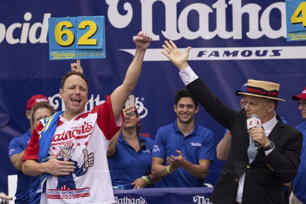 Joey Chestnut celebrates after winning his 16th championship title during the 2023 Nathan's Famous Fourth of July hot dog eating contest in the Coney Island section of the Brooklyn borough of New York, Tuesday, July. 4, 2023. (AP Photo/Yuki Iwamura)