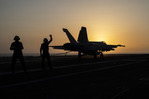 A fighter jet lands on the USS Dwight D. Eisenhower, also known as "IKE," in the Red Sea on Tuesday, June 11, 2024. The U.S.-led campaign against Iran-backed Houthi rebels has turned into the most intense running sea battle the Navy has faced since World War II. That's what its leaders and experts tell The Associated Press, whose journalists visited U.S. ships off Yemen in recent days. (AP Photo/Bernat Armangue)