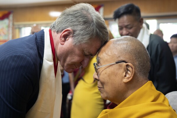 In this photo shared by the Office of the Dalai Lama, Republican Rep. Michael McCaul, left, is greeted by Tibetan spiritual leader the Dalai Lama, at the Tibetan leader's residence in Dharamshala, India, Wednesday, June 19, 2024. (Tenzin Choejor/Office of the Dalai Lama via AP)