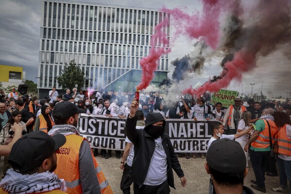 Protestors attend a silent march called by the mother of 17-year-old Nahel Merzouk who was killed by police to mark one year since his death, in Nanterre, west of Paris, Saturday, June 29, 2024. The murder of 17-year-old Nahel by an on-duty police officer in June 2023 sparked riots across France. (AP Photo/Aurelien Morissard)