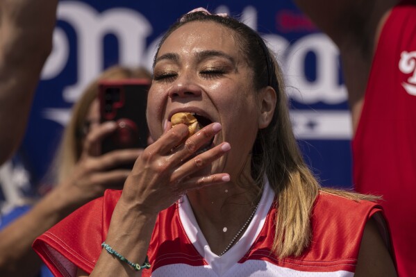 Competitive eater Miki Sudo eats a hot dog during the 2023 Nathan's Famous Fourth of July hot dog eating contest in the Coney Island section of the Brooklyn borough of New York, Tuesday, July. 4, 2023. (AP Photo/Yuki Iwamura)