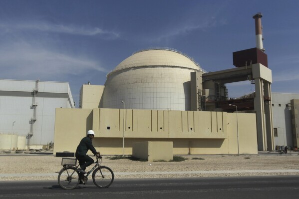 FILE - A worker rides a bike in front of the reactor building of the Bushehr nuclear power plant, just outside the southern city of Bushehr, Iran, on Oct. 26, 2010. Iran will elect a new president Friday, on June 28, 2024, after the death of hard-line President Ebrahim Raisi. Whoever takes the helm in the country will inherit Iran's rapidly advancing nuclear program, which now enriches uranium closer than ever to weapons-grade levels. (AP Photo/Majid Asgaripour, File)