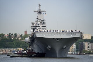 FILE - Sailors and military service personnel arrive on the USS Wasp amphibious assault ship on the Hudson River during fleet week, May 24, 2023, in New York. (AP Photo/John Minchillo, FIle)