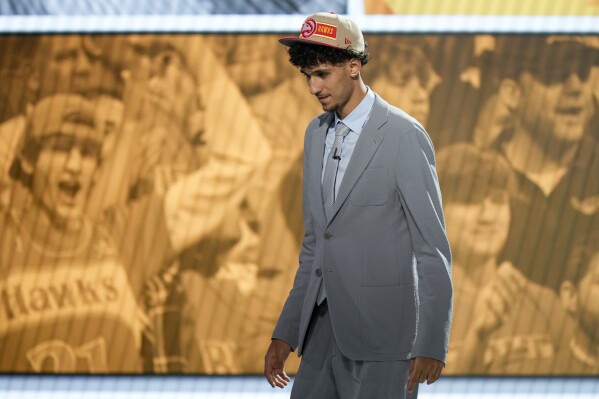 Zaccharie Risacher, walks across the stage after being selected as the first overall pick by the Atlanta Hawks in the first round of the NBA basketball draft, Wednesday, June 26, 2024, in New York. (AP Photo/Julia Nikhinson)
