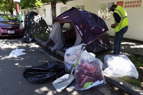 Contents of a tent are seen in bags as workers dismantle the tent after Portland police detained the person residing there on Friday, June 28, 2024, in Portland, Ore. The Supreme Court cleared the way for cities to enforce bans on homeless people sleeping outside in public places on Friday, overturning a ruling from a California-based appeals court that found such laws amount to cruel and unusual punishment when shelter space is lacking. (AP Photo/Jenny Kane)