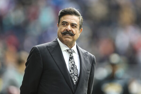 FILE - Jacksonville Jaguars owner Shad Khan on the field before an NFL football game against the Miami Dolphins at Tottenham Hotspur Stadium in London, Sunday, Oct. 17, 2021. Jacksonville approved a $1.4 billion “stadium of the future” renovation for the Jaguars. On Tuesday, June 26,2024, the proposal passed by a 14-1 vote. It calls for a 55-45% financial split, with each side contributing $625 million to the $1.25 billion build. Jacksonville, which won’t levy any new taxes to fund the rebuild, would chip in another $150 million in deferred maintenance to get EverBank Stadium ready for construction in 2026. (AP Photo/Gary McCullough, File)
