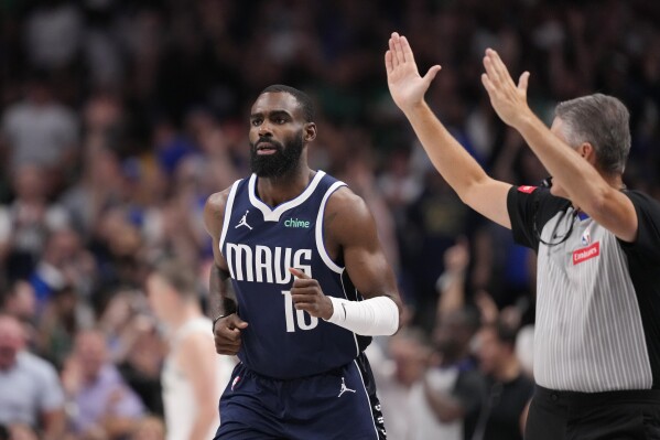 Dallas Mavericks forward Tim Hardaway Jr. (10) runs up court after scoring against the Boston Celtics during the second half in Game 4 of the NBA basketball finals, Friday, June 14, 2024, in Dallas. (AP Photo/Julio Cortez)