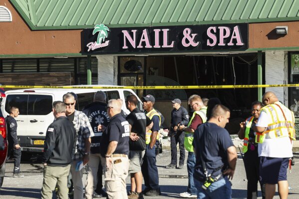Emergency personnel respond to a scene after a vehicle drove into Hawaii Nail & Spa, killing and injuring multiple people Friday, June 28, 2024, in Deer Park, N.Y. (Steve Pfost/Newsday via AP)