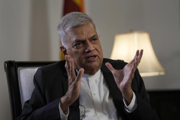 FILE- Sri Lanka's new prime minister Ranil Wickremesinghe gestures during an interview with The Associated Press in Colombo, Sri Lanka, Saturday, June 11, 2022. Sri Lankan President Wickremesinghe on Tuesday, Aug. 1, 2022, said the number of COVID-19 patients and deaths are rising in the Indian ocean island nation and urged the citizen to get themselves inoculated with the 4th dose of the vaccine in a bid to prevent a possible outbreak of the virus. (AP Photo/Eranga Jayawardena, File)