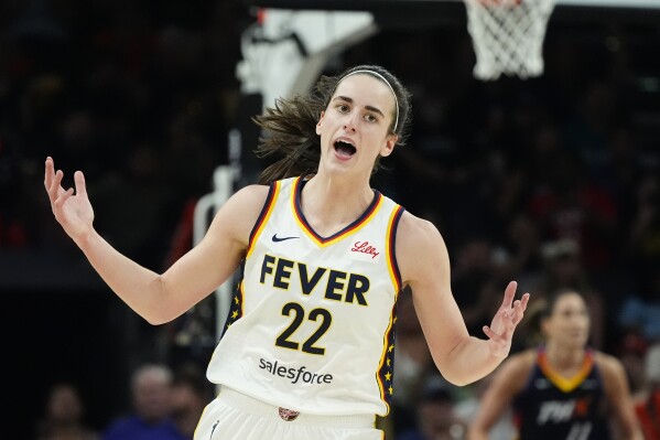 Indiana Fever guard Caitlin Clark celebrates after making a 3-point basket against the Phoenix Mercury during the second half of a WNBA basketball game Sunday, June 30, 2024, in Phoenix. (AP Photo/Ross D. Franklin)