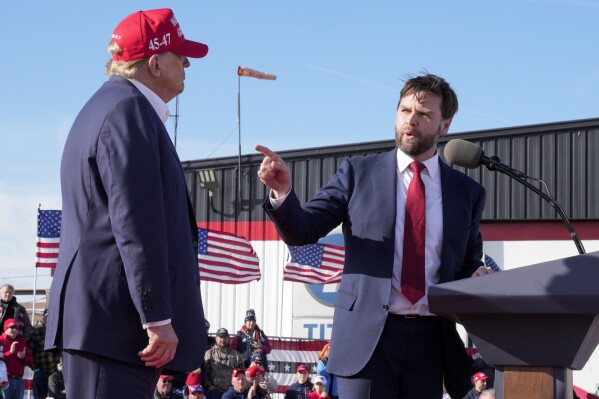 Sen. J.D. Vance, R-Ohio, right, points toward Republican presidential candidate former President Donald Trump at a campaign rally on March 16, 2024, in Vandalia, Ohio. (AP Photo/Jeff Dean, File)