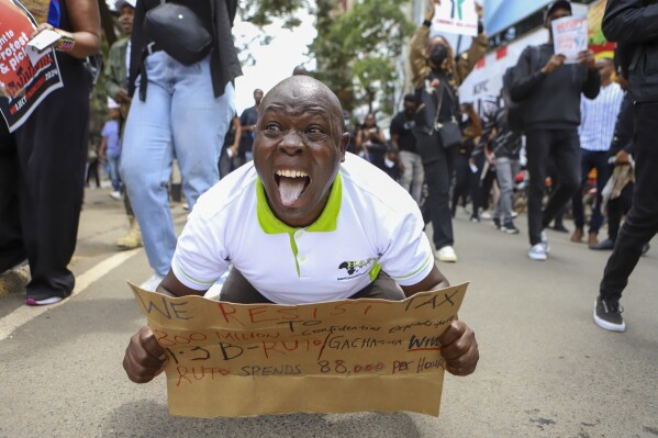 Demonstrators protest against proposed tax hikes in a finance bill that is due to be tabled in parliament in Nairobi, Kenya, Tuesday, June 18, 2024. Civil society groups say that despite the dozens of arrests, demonstrations and a planned sit-down outside the parliament buildings will continue. (AP Photo/Andrew Kasuku)