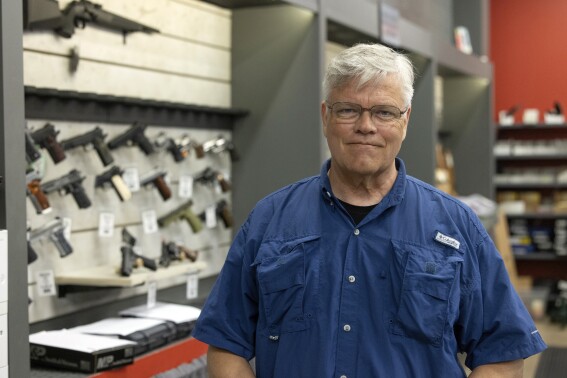 Maxon Shooter's Supplies owner Dan Eldridge poses in his store in Des Plaines, Ill., Tuesday, June 25, 2024. A new national divide is emerging among states over whether to track sales by gun stores. A California law taking effect Monday will require credit card networks to provide banks with special retail codes to assign to gun stores. By contrast, new laws taking effect in Georgia, Iowa, Tennessee and Wyoming will prohibit the use of special gun shop codes in financial transactions. A total of 17 states have passed some sort of limit on category codes for gun retailers, while California has been joined by Colorado and New York. (AP Photo/Teresa Crawford)