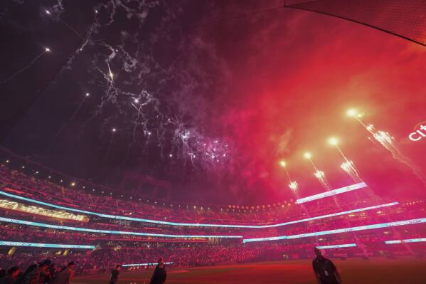 Fans watch a pyrotechnics display after a baseball game between the New York Mets and the Houston Astros, Friday, June 28, 2024, in New York. (AP Photo/Frank Franklin II)
