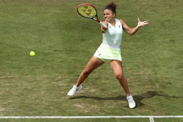 Italy's Jasmine Paolini returns the ball to Britain's Katie Boulter on day six of the Rothesay International tennis tournament at Devonshire Park, Eastbourne, England, Thursday June 27, 2024. (George Tewkesbury/PA via AP)