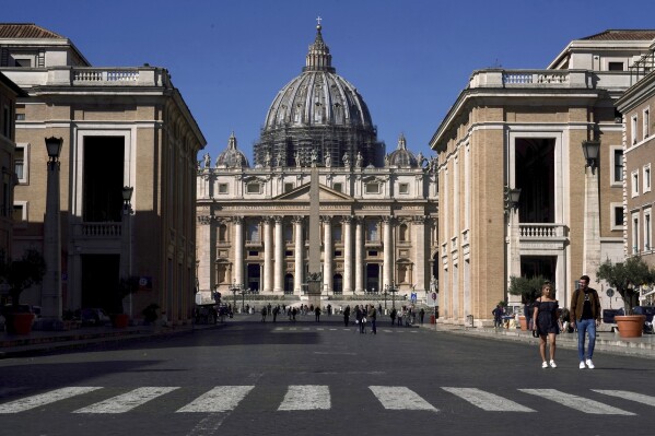 FILE - A view of St. Peter's Basilica at the Vatican, March 11, 2020. The Vatican was forced to stand trial in a London court Wednesday, as a British financier sought to recover from the reputational harm he said he suffered as a result of a Vatican investigation into its 350 million euro investment in a London property.(AP Photo/Andrew Medichini, File)