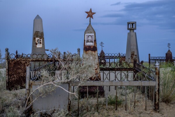 Graves are visible near the dried-up Aral Sea outside Aralsk, Kazakhstan, Monday, July 3, 2023. (AP Photo/Ebrahim Noroozi)