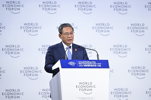 In this photo released by Xinhua News Agency, Chinese Premier Li Qiang addresses the opening plenary of the 15th Annual Meeting of the New Champions, also known as the Summer Davos, in Dalian, northeast China's Liaoning Province, Tuesday, June 25, 2024. (Li Xiang/Xinhua via AP)