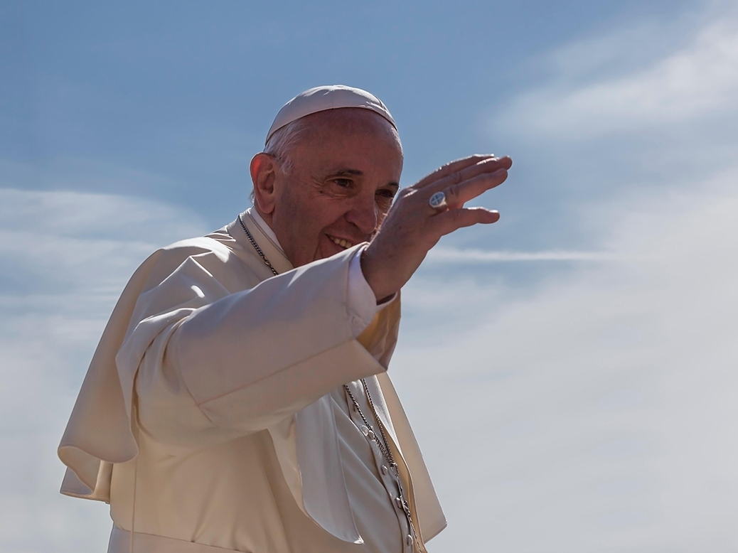 Pope Francis waving from pope mobile in the Vatican