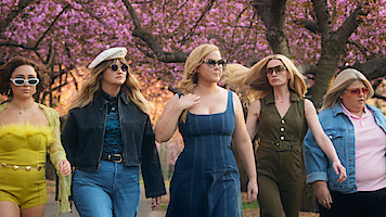 Amy Schumer in Kinda Pregnant walking alongside female members of the cast.