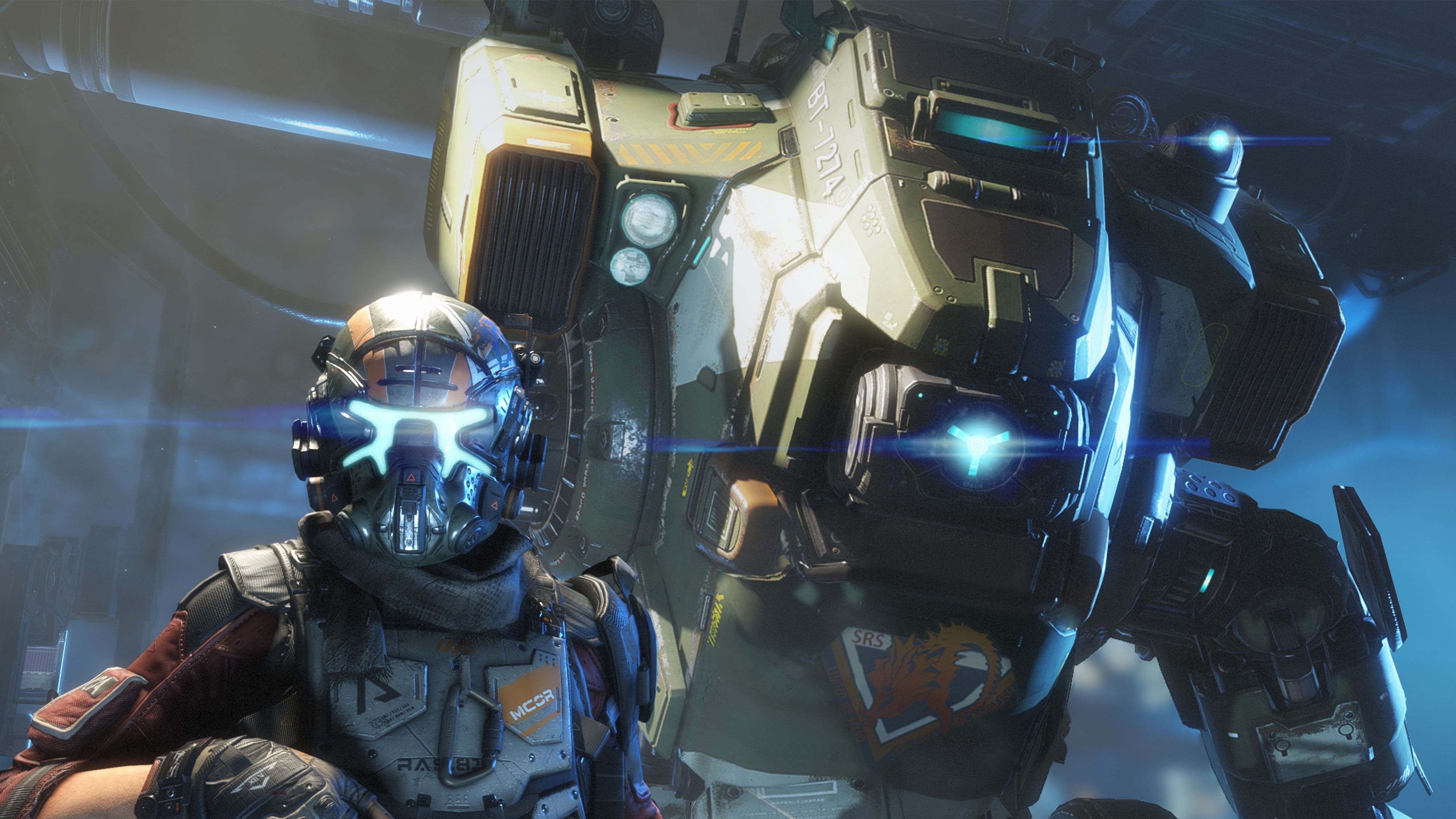 A pilot and titan stand together. 