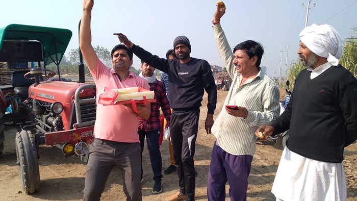 Farmers in west Uttar Pradesh's Muzaffarnagar celebrate withdrawal of the three farm laws that have been at the center of farmers' protests for over a year.