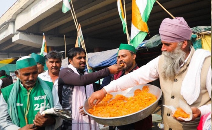 Celebrations in full swing at the Ghazipur border in Delhi after PM Modi's announcement.