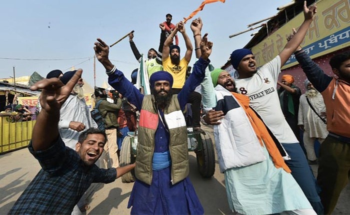 Farmers celebrate the repeal of the laws at the Singhu border between Delhi and Haryana.