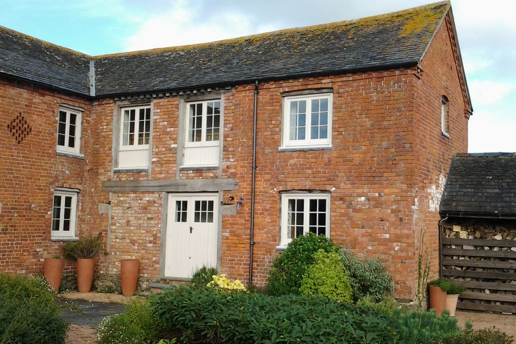 Escape to a red-brick cottage surrounded by fields at The Dairy at Collfryn Farm in Powys, Wales