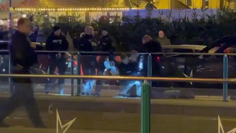 Videos show German police detaining suspect after car driven into crowd at Christmas market
